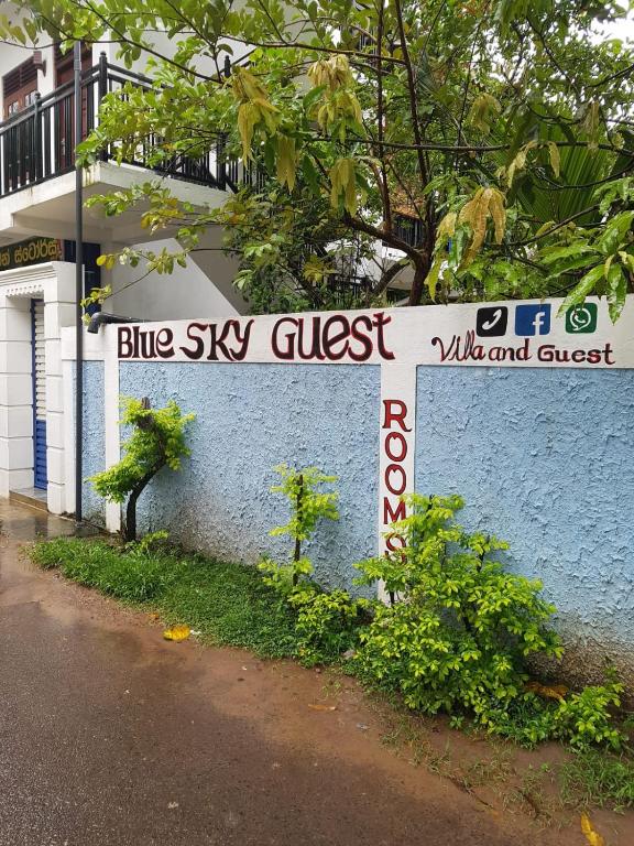 a blue sky guest sign on a wall at Blue sky villa in Mirissa
