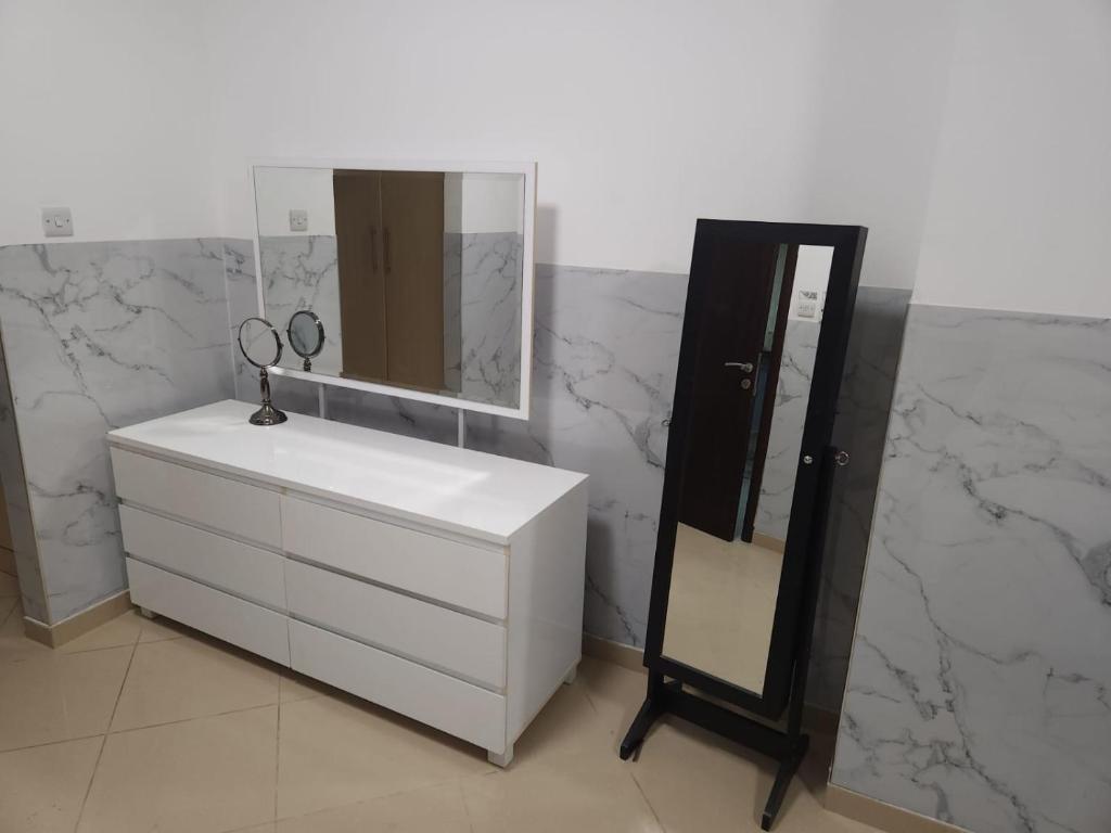 a bathroom with a white sink and a mirror at 1 BHK - Concorde Tower - JLT Cluster H in Dubai
