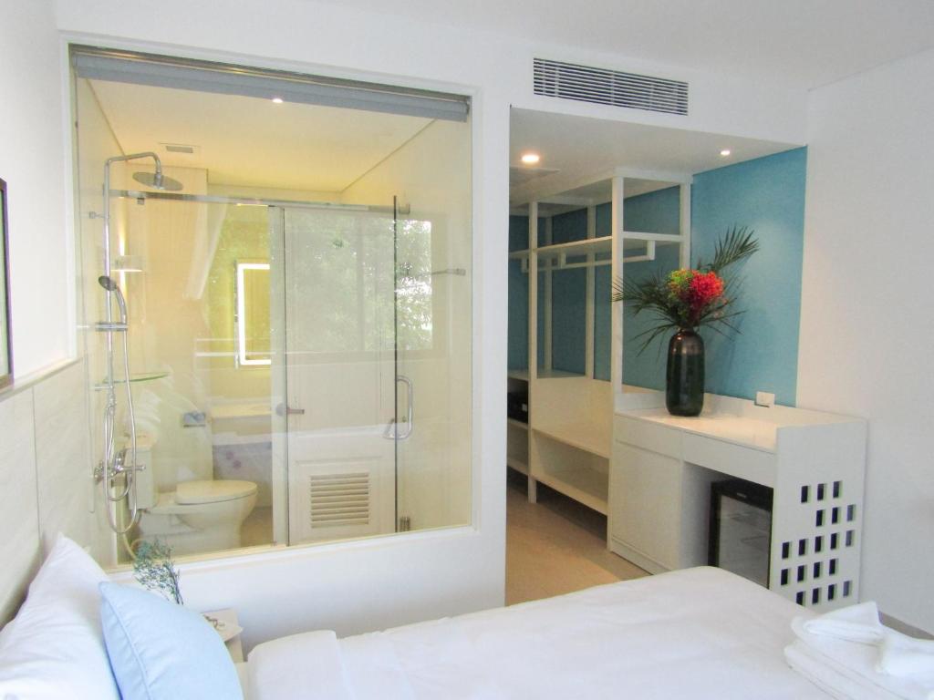 La salle de bains est pourvue d'une douche en verre et de toilettes. dans l'établissement HAYA Sea View Hotel Phu Quoc, à Duong Dong