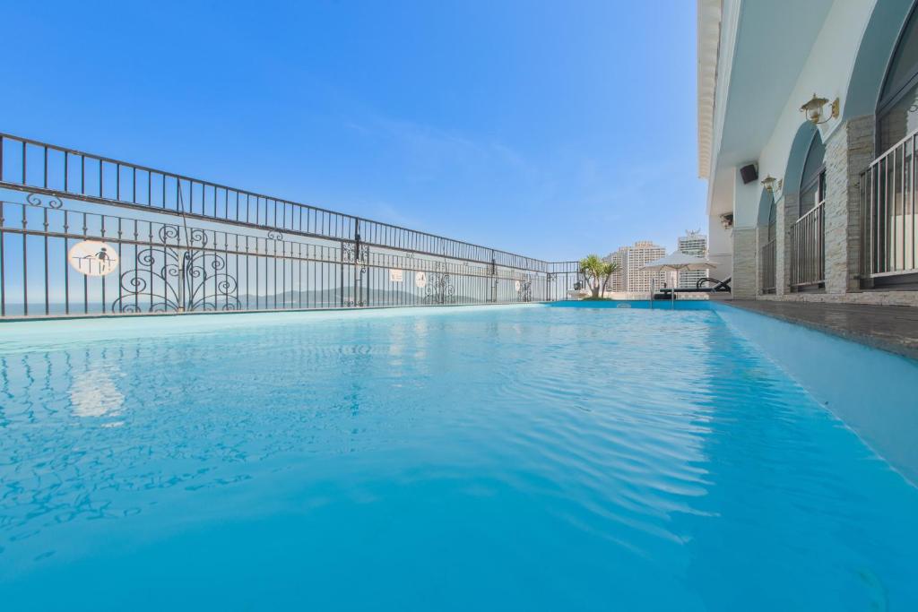 a swimming pool in a building with blue water at Daphovina Hotel in Nha Trang