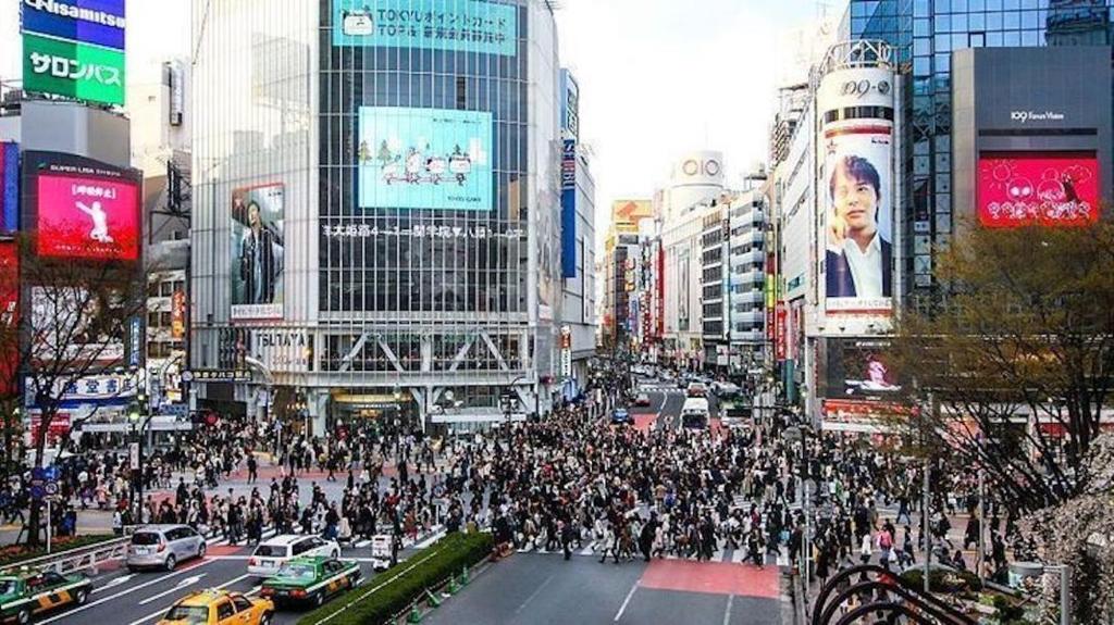a large crowd of people crossing a busy city street at 10 minutes direct to Shibuya Crossing! Heart of Tokyo! Kamiuma in Tokyo