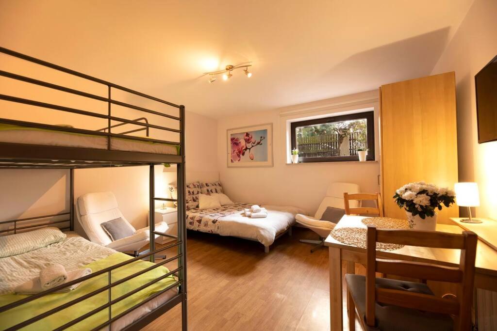 a bedroom with two bunk beds and a living room at Pegaz 3 in Sopot
