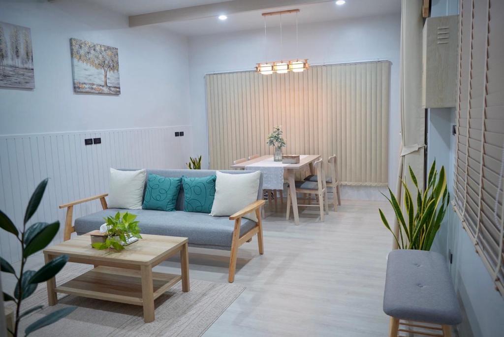 uma sala de estar com um sofá e uma mesa em Room61-รูม61 em Phuket
