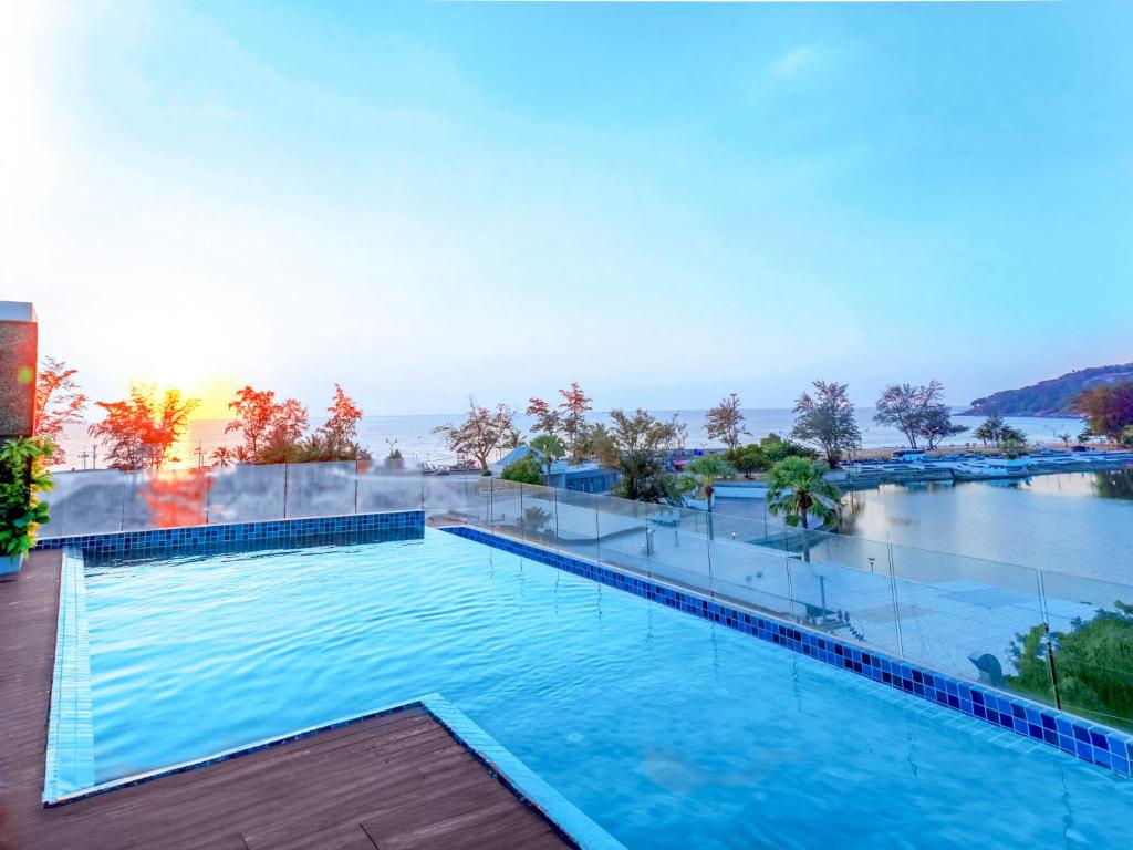 a swimming pool on the roof of a building at Phoenix Hotel Karon Beach in Karon Beach