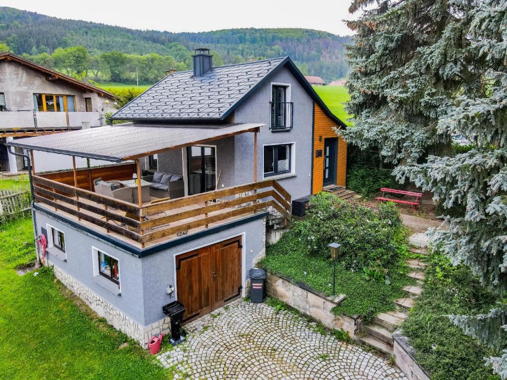 a small house with a deck on top of it at Residenz Waldfrieden in Garnsdorf