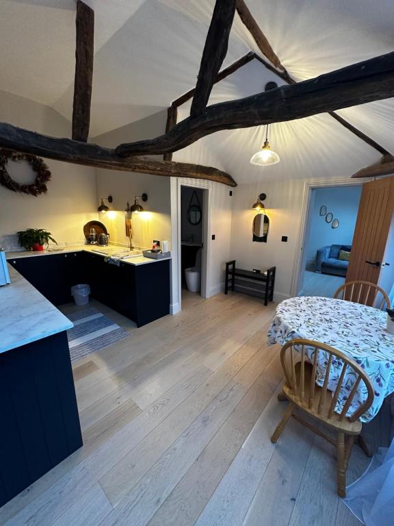 a kitchen and living room with a wooden floor at The stables at the Grange in York