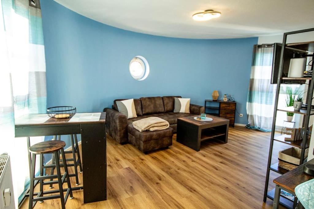 a living room with a couch and a table at Fabrikdesign Düren in Düren - Eifel