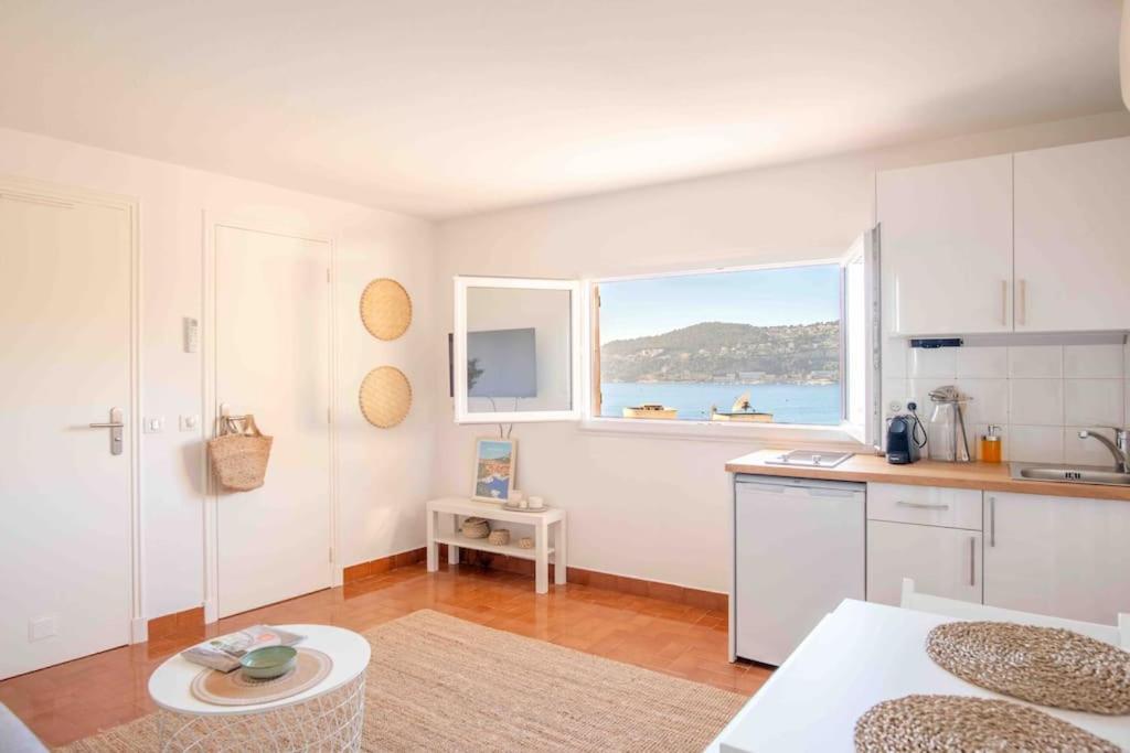 a kitchen with a view of the ocean at Studio vue mer climatisé à 100m des plages in Saint-Jean-Cap-Ferrat