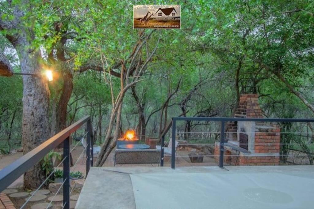 a fire place in a park next to a fire at Nag-Apie Vakansiehuis in Marloth Park