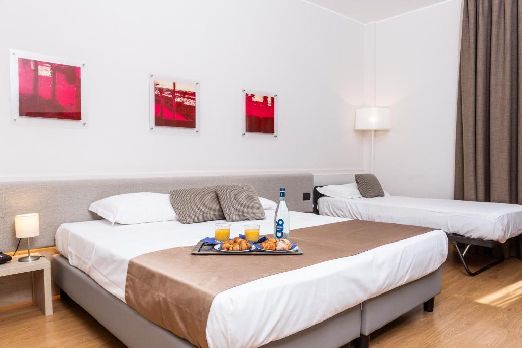 Postel nebo postele na pokoji v ubytování Helios Hotel & Terrazza MIA