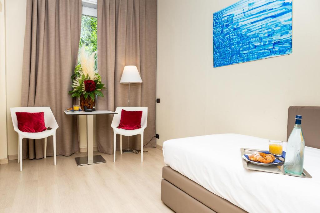 Postel nebo postele na pokoji v ubytování Helios Hotel & Terrazza MIA