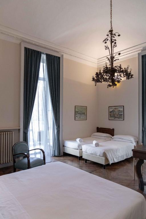 Postel nebo postele na pokoji v ubytování Hotel Bologna