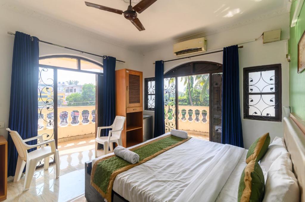 Ένα ή περισσότερα κρεβάτια σε δωμάτιο στο De Alara Calangute