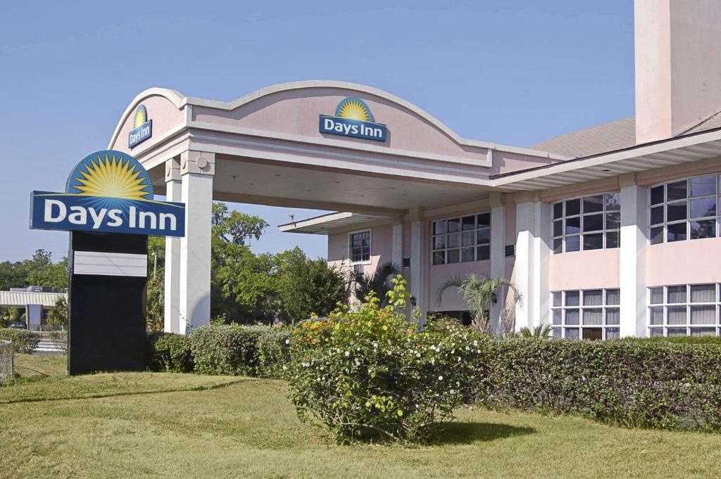 a day inn sign in front of a building at Days Inn by Wyndham Gainesville University in Gainesville