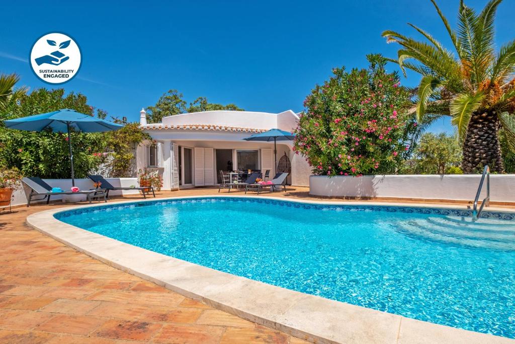 a swimming pool in front of a villa at Villa Sunshine by Algarve Vacation in Armação de Pêra