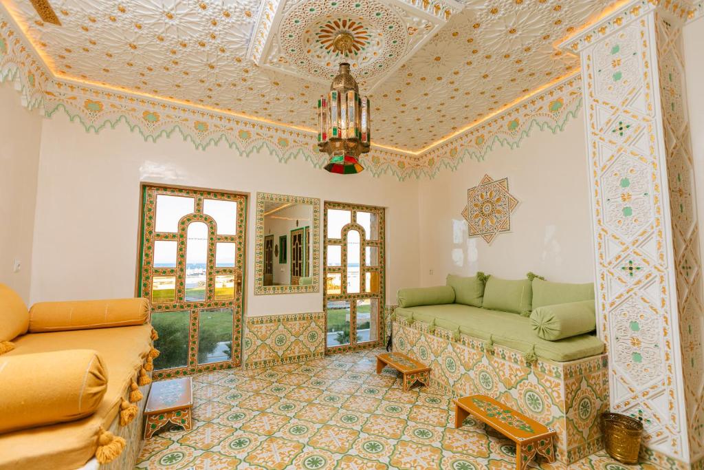 a living room with a couch and a ceiling at Colorful traditional Riad w/views of Spain in Tangier
