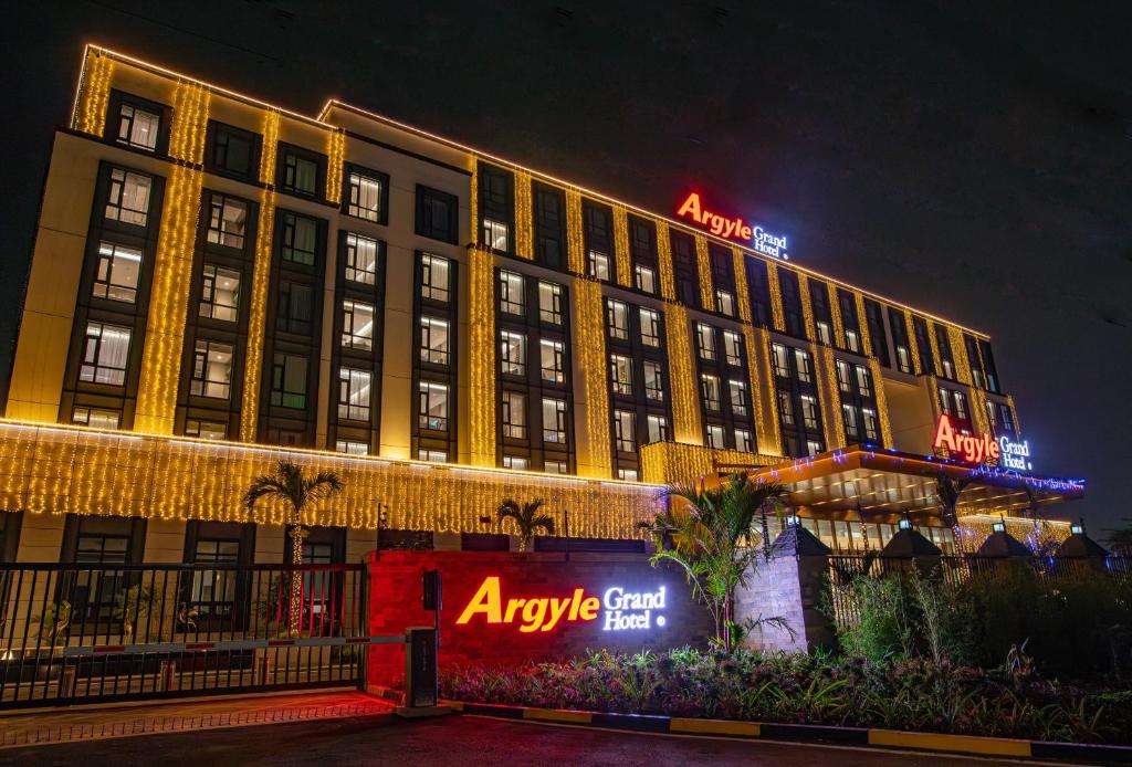 a large building with anagency sign on it at night at Argyle Grand Hotel Nairobi Airport in Nairobi