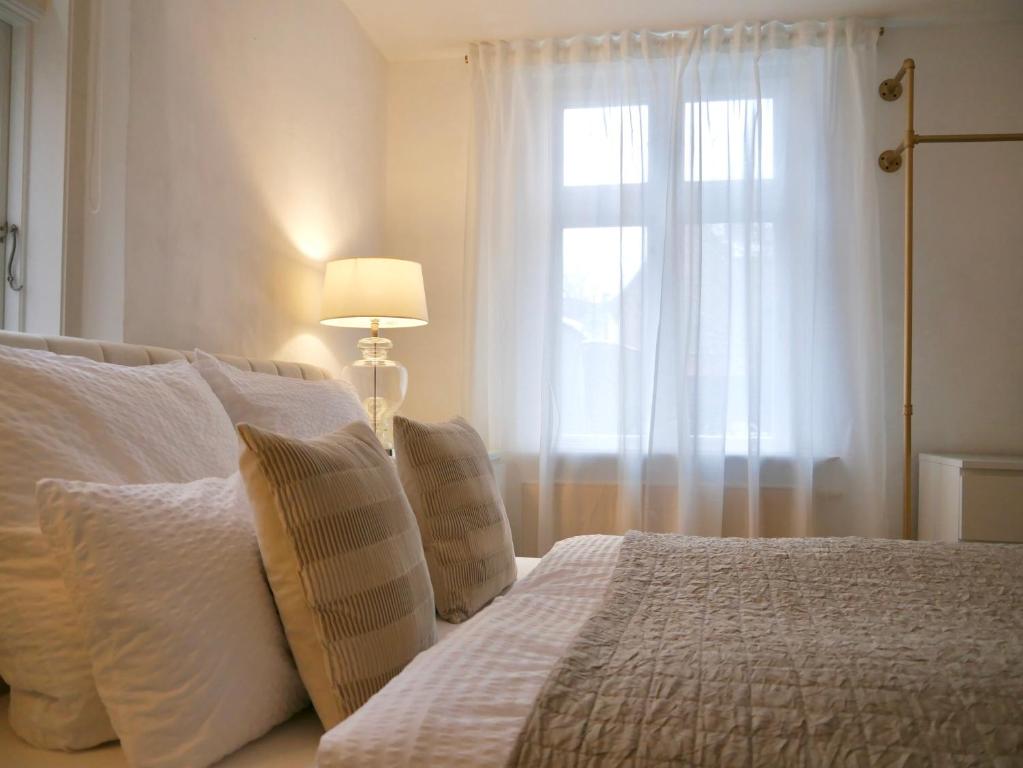 リューネブルクにあるStay Hygge - Zentrales Altstadt-Apartment in Lüneburg mit kostenfreiem Parkplatzのベッドルーム1室(枕付きのベッド1台、窓付)