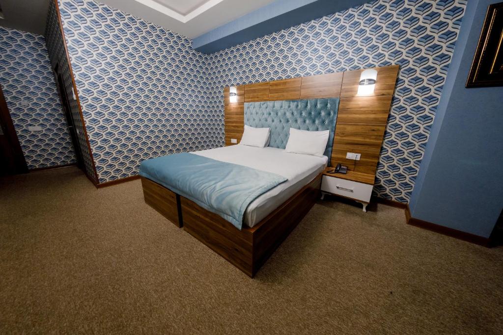 Postel nebo postele na pokoji v ubytování Royal Sapphire Hotel
