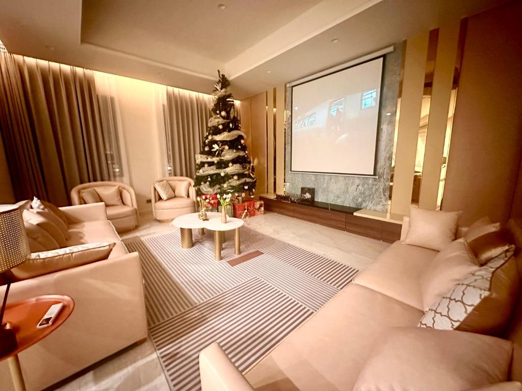 a living room with a christmas tree and a television at Shine HolliDay Villa HaNoi in Hanoi