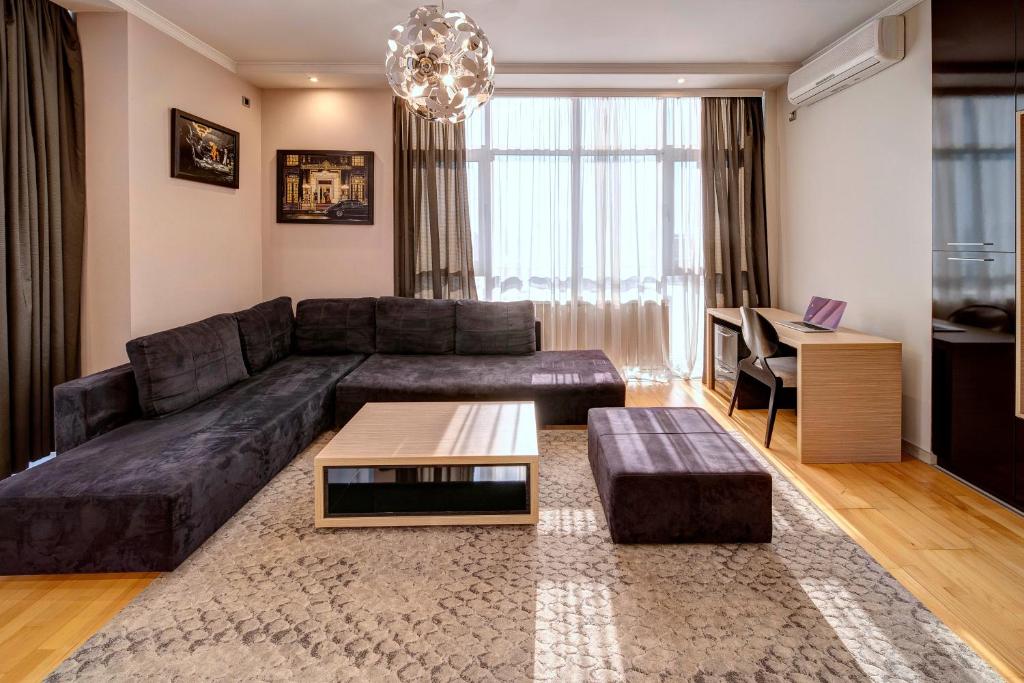 a living room with a couch and a table at Apart K Apartments & Rooms in Belgrade