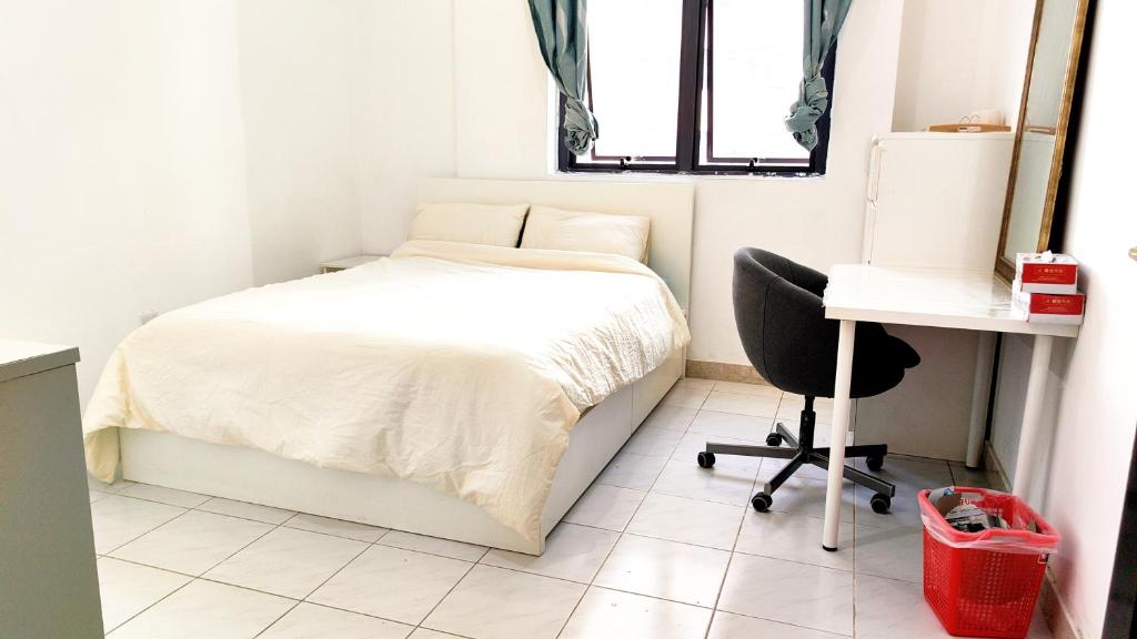 a small bedroom with a bed and a desk at Ms. Zhang Apartment in Abu Dhabi