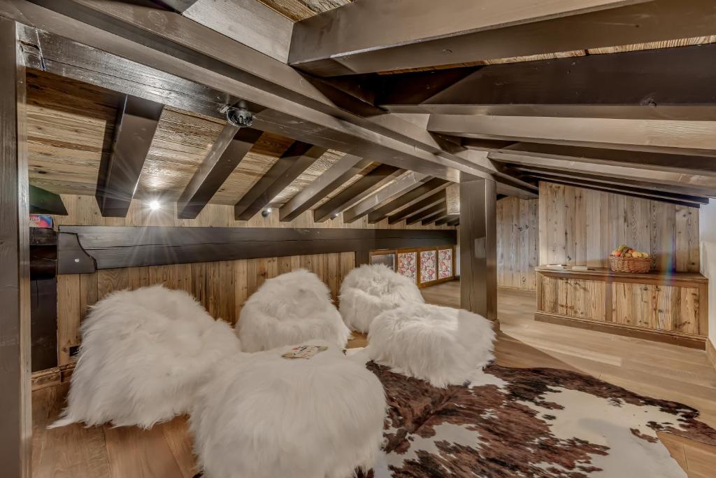 three white chairs sitting on a rug in a room at Hotel & Spa Le Val d'Isère in Val-d'Isère