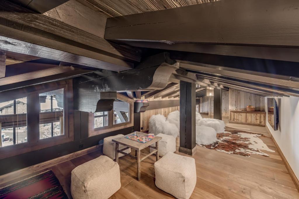 a living room with a couch and a table at HOTEL LE VAL D&#39;ISERE in Val-d&#39;Isère