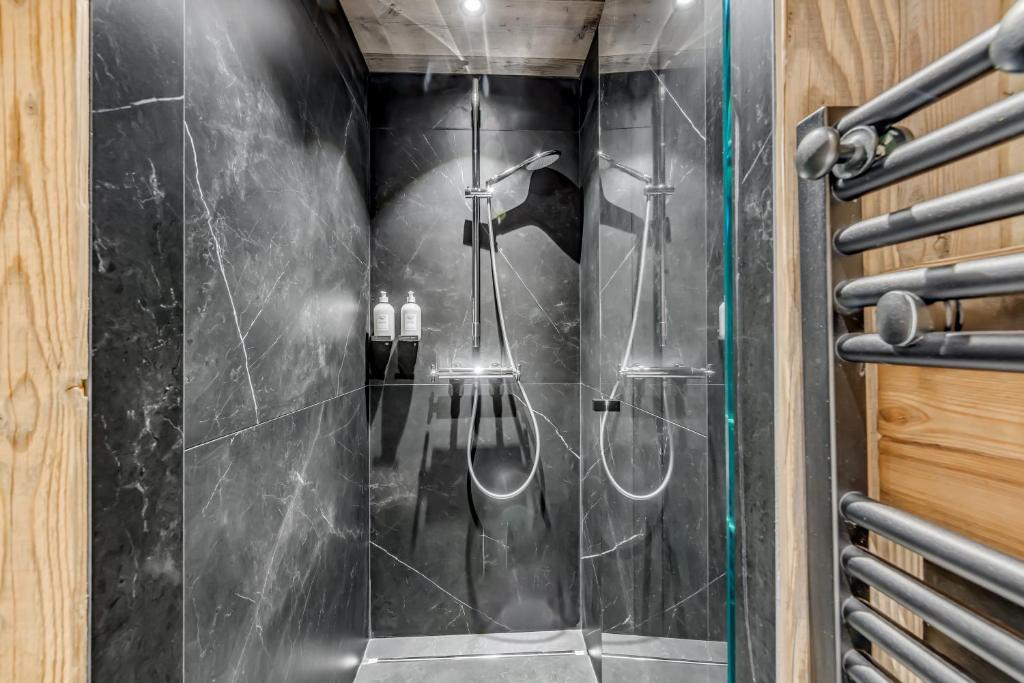 a walk in shower with a glass door at Hotel & Spa Le Val d'Isère in Val-d'Isère