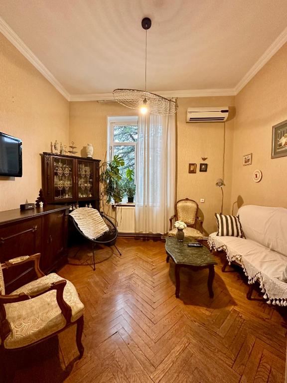 a living room with a couch and a table at Bright apartment in front of Vake Square in Tbilisi City