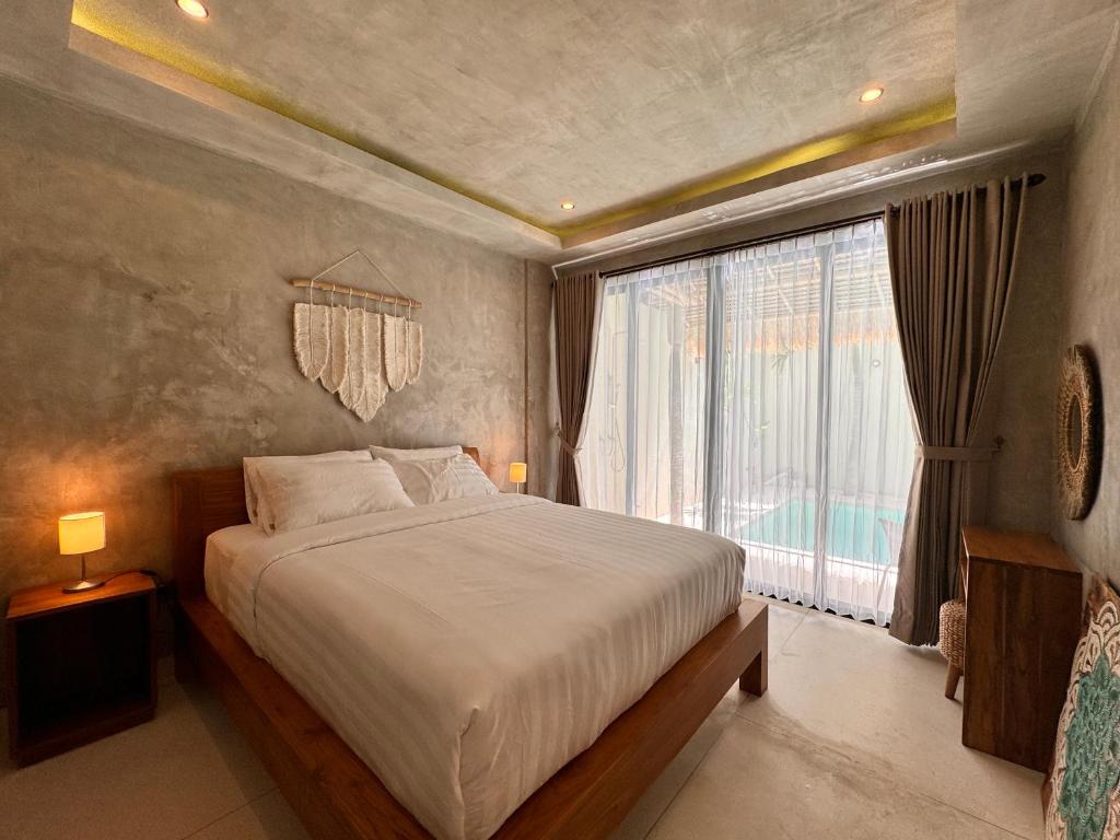 Кровать или кровати в номере Villa de Mer Bali