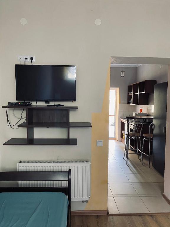 a living room with a flat screen tv on a wall at Hostel Serge in Lviv