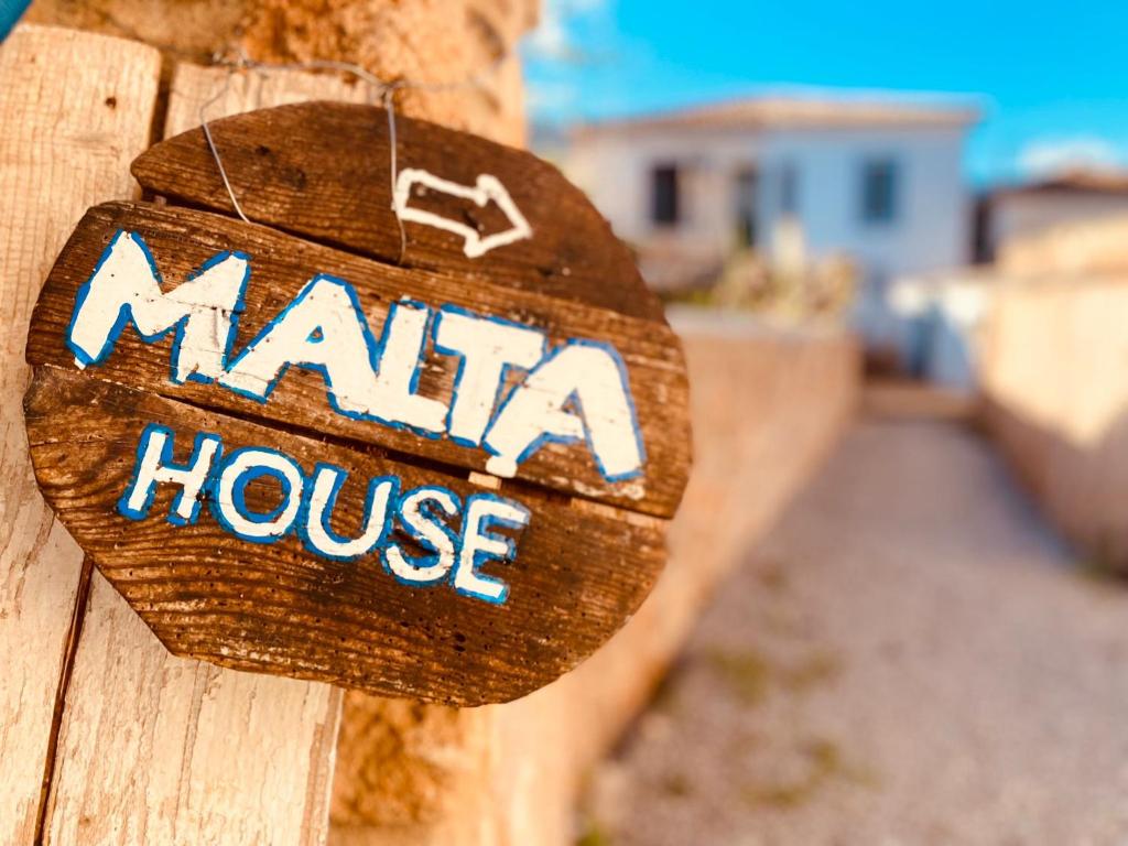 een bord voor een mahi huis op een houten hek bij Malta House in Galaxidi in Galaxidhion