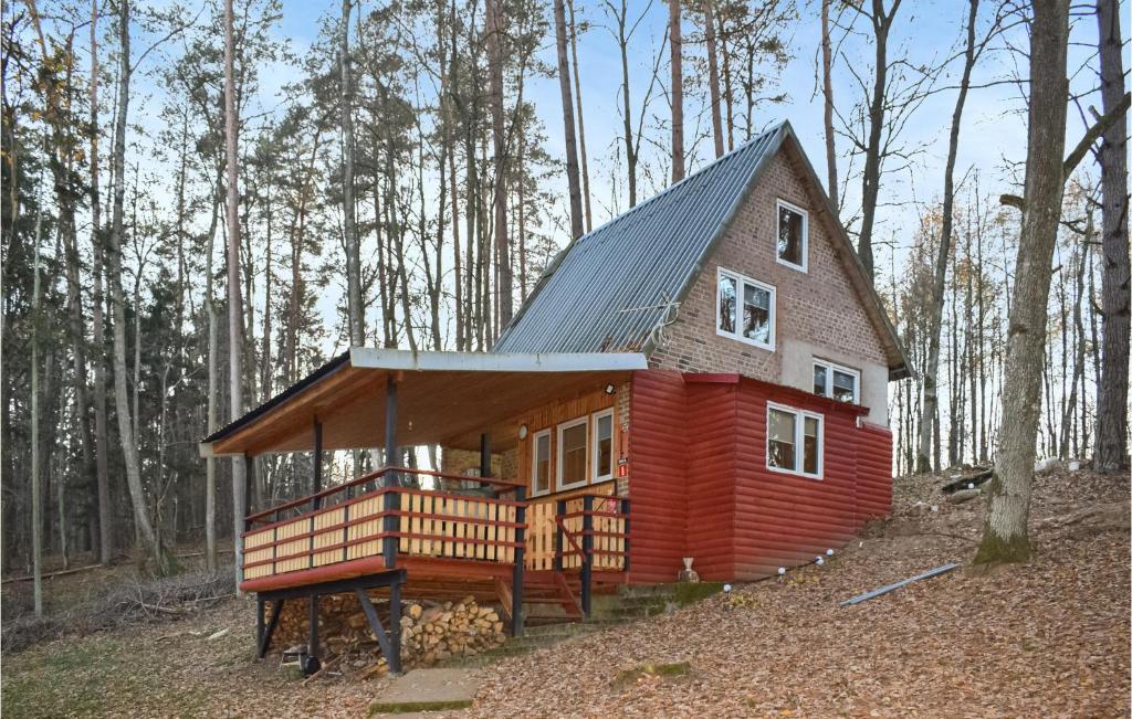 a small house in the middle of a forest at Lovely Home In Wilimy With House A Panoramic View in Dadaj