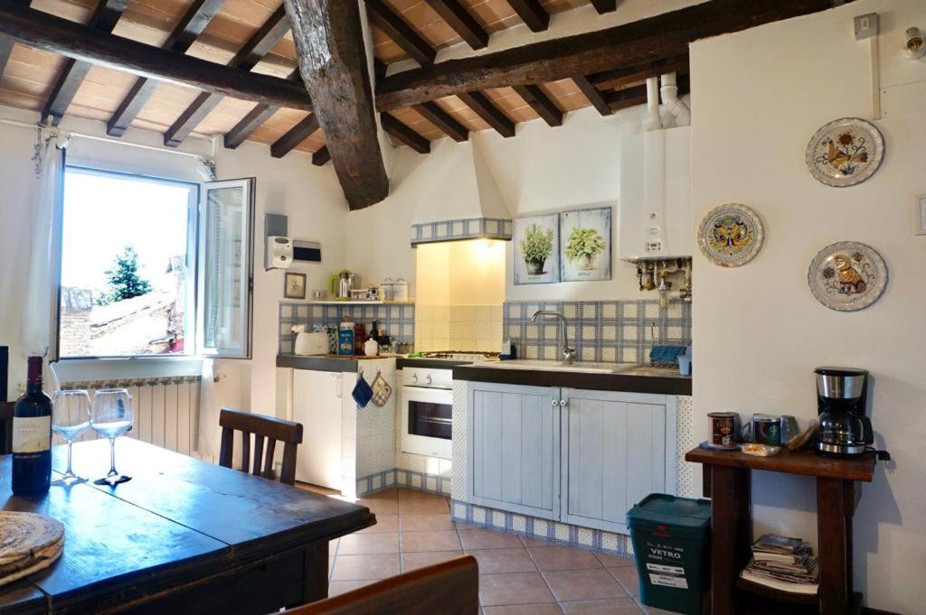 a kitchen with a table and a counter top at La tana del priore in Perugia