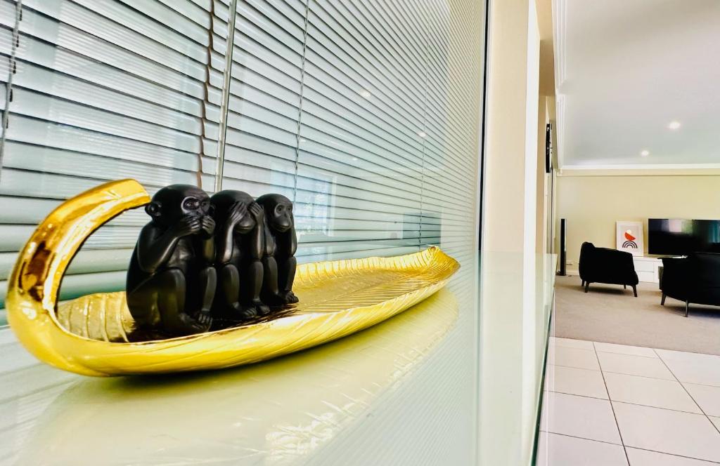 a sculpture of three people in a banana boat at Three Monkeys Residence in Kellyville