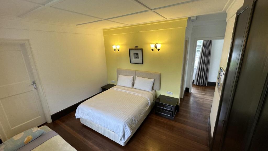 Postel nebo postele na pokoji v ubytování Bukit Ruil Bungalow - Clementine Suite