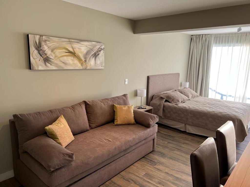 a living room with a couch and a bed at Guemes 540 Studio in San Carlos de Bariloche