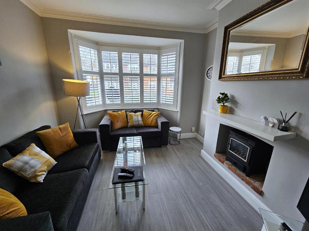 a living room with a couch and a fireplace at Knighton Villa in Leicester