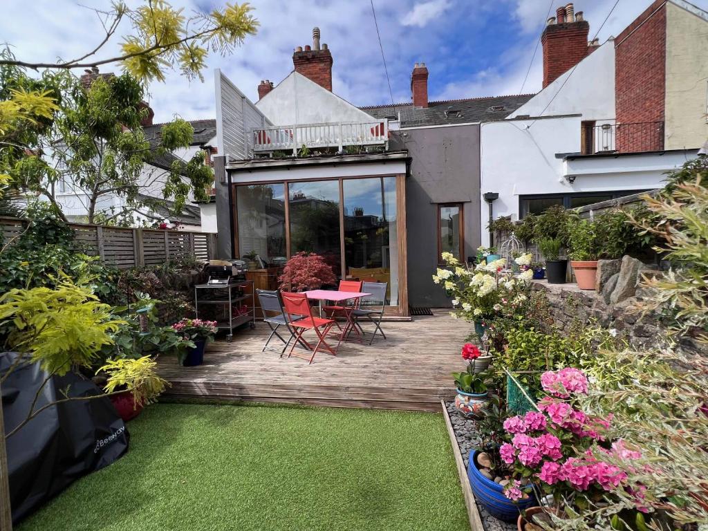 a patio with a table and chairs and flowers at Stylish Ground Floor 2 Bedroom Apartment In Pontcanna in Cardiff