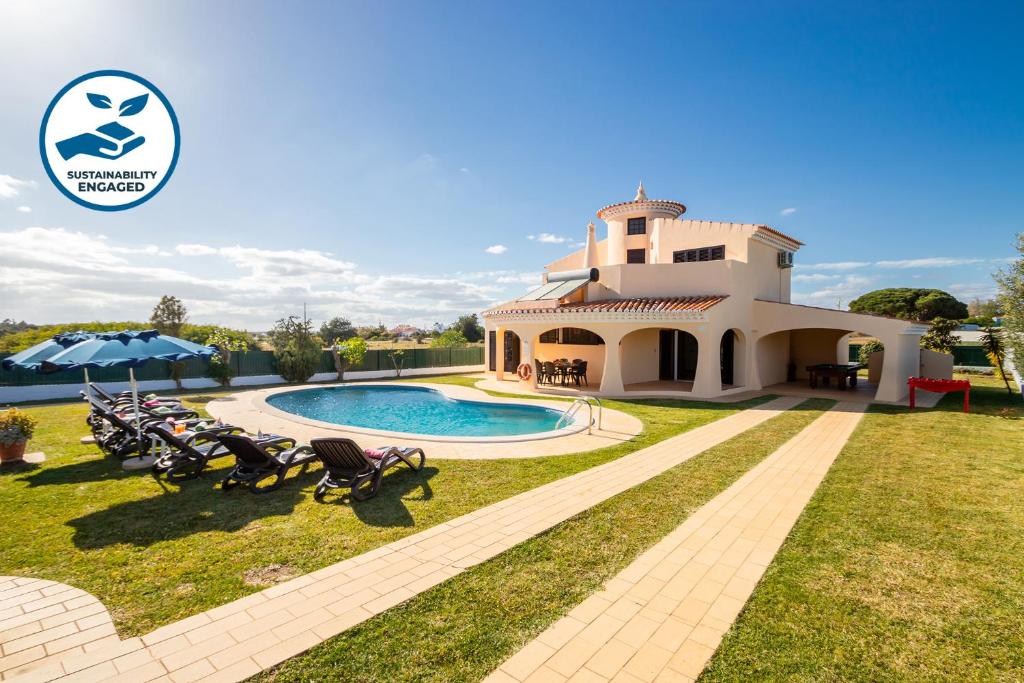 a villa with a swimming pool in a yard at Villa Ushuaia by Algarve Vacation in Guia