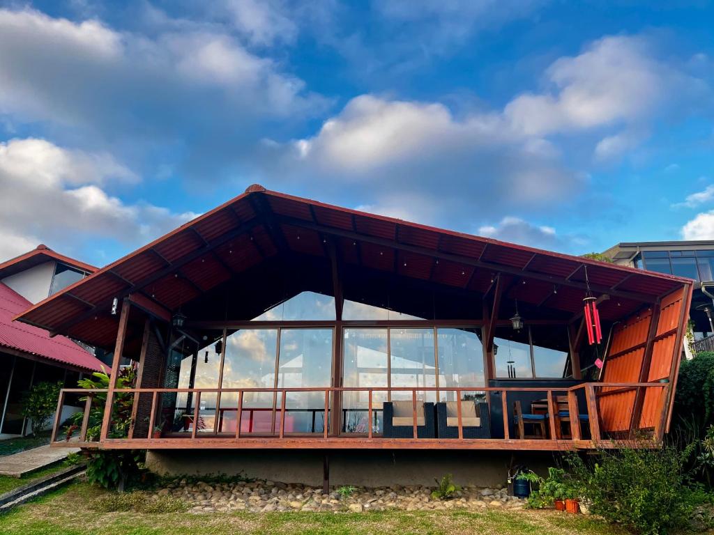 a house with a large roof on top of it at Chalet Zen Bella Vista in Ángeles