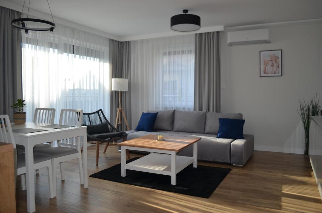 a living room with a couch and a table at Apart city break apartament in Świebodzice