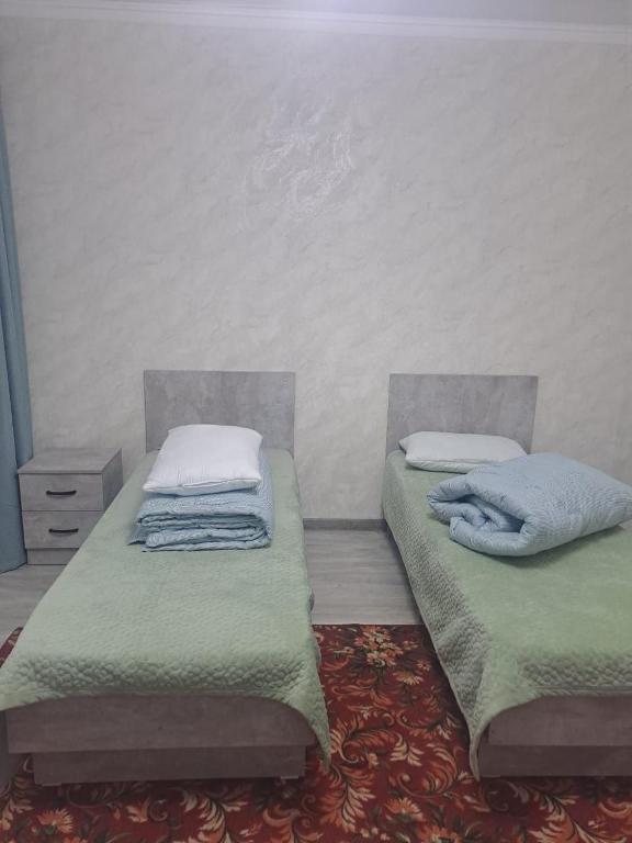 Postel nebo postele na pokoji v ubytování GuestHouse "ERKIN"
