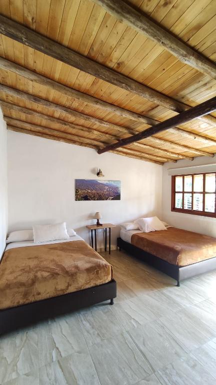 Llit o llits en una habitació de Hotel Boutique Santa Clara Mesa de los Santos