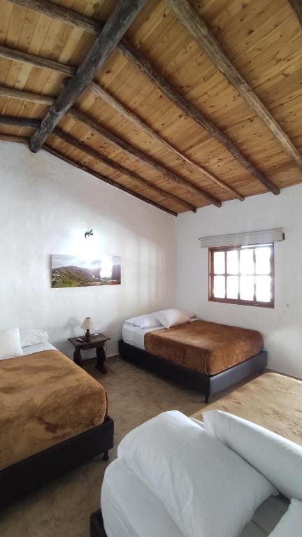 Llit o llits en una habitació de Hotel Boutique Santa Clara Mesa de los Santos