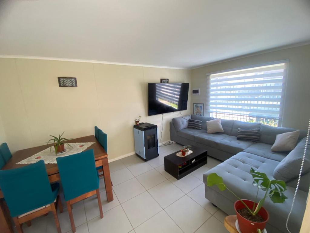 a living room with a couch and a table at Casas Cartes in Valdivia