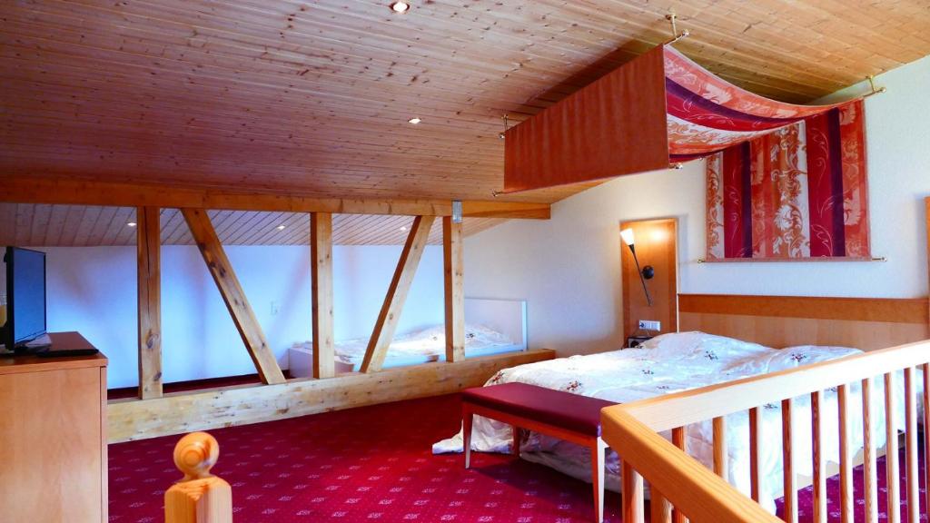a bedroom with two bunk beds and a balcony at Öko-Landhotel Basler Hof in Lauterbach
