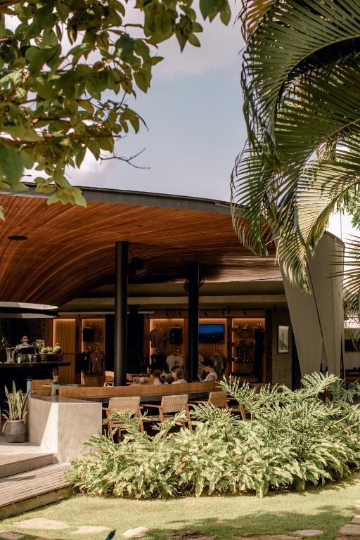 a modern house with a wooden roof at Wave House Boutique Surf Retreat - Adults Only in Canggu