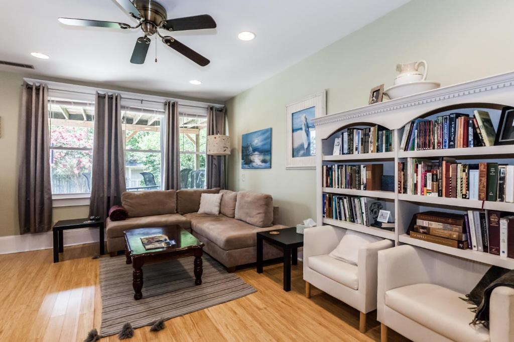 a living room with a large book shelf filled with books at Cozy Apartment in Downtown Neighborhood in Columbia